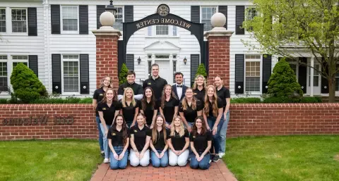 Admissions tour guides in front of Gill Center