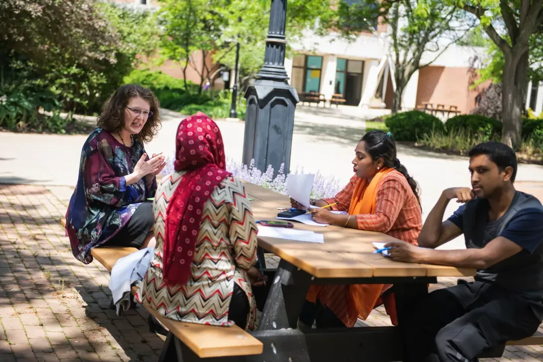 ACCESS student in Advanced Speaking and Listening class sitting outdoors